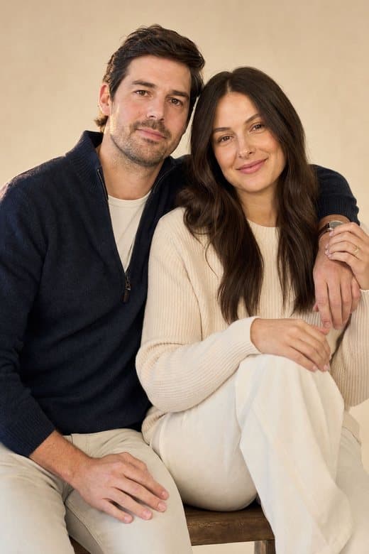 A couple sitting close together, relaxed and connected